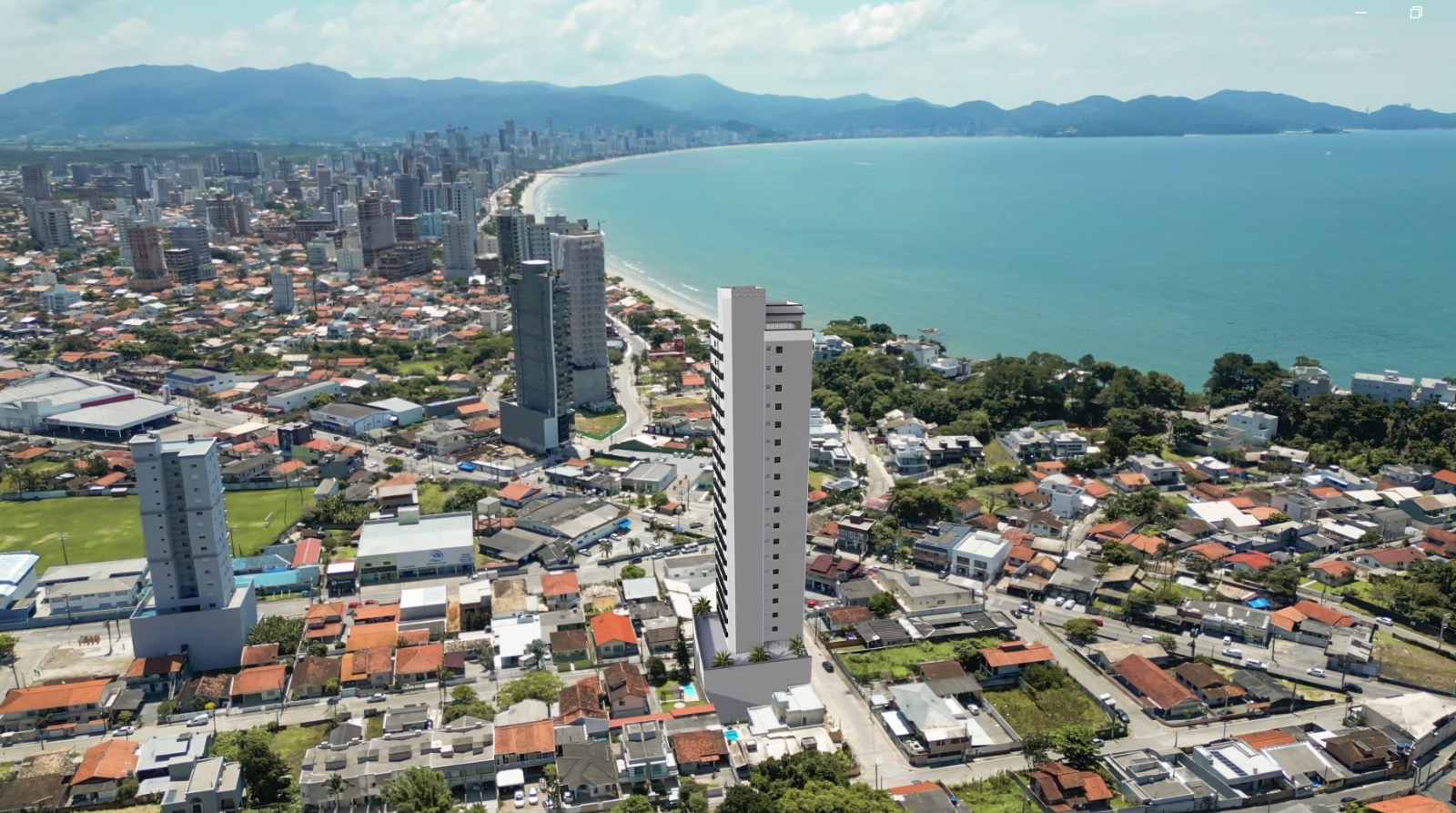 Vista aérea do Residencial The Place com a orla de Porto Belo ao fundo